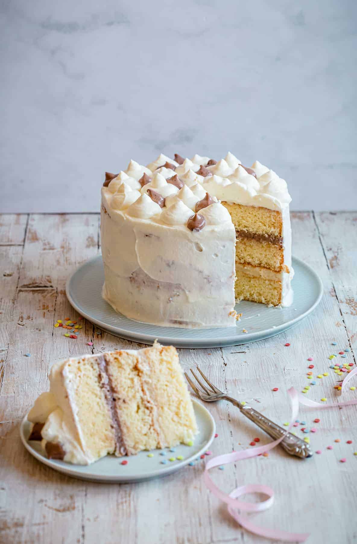 a yellow layer cake with a slice aside