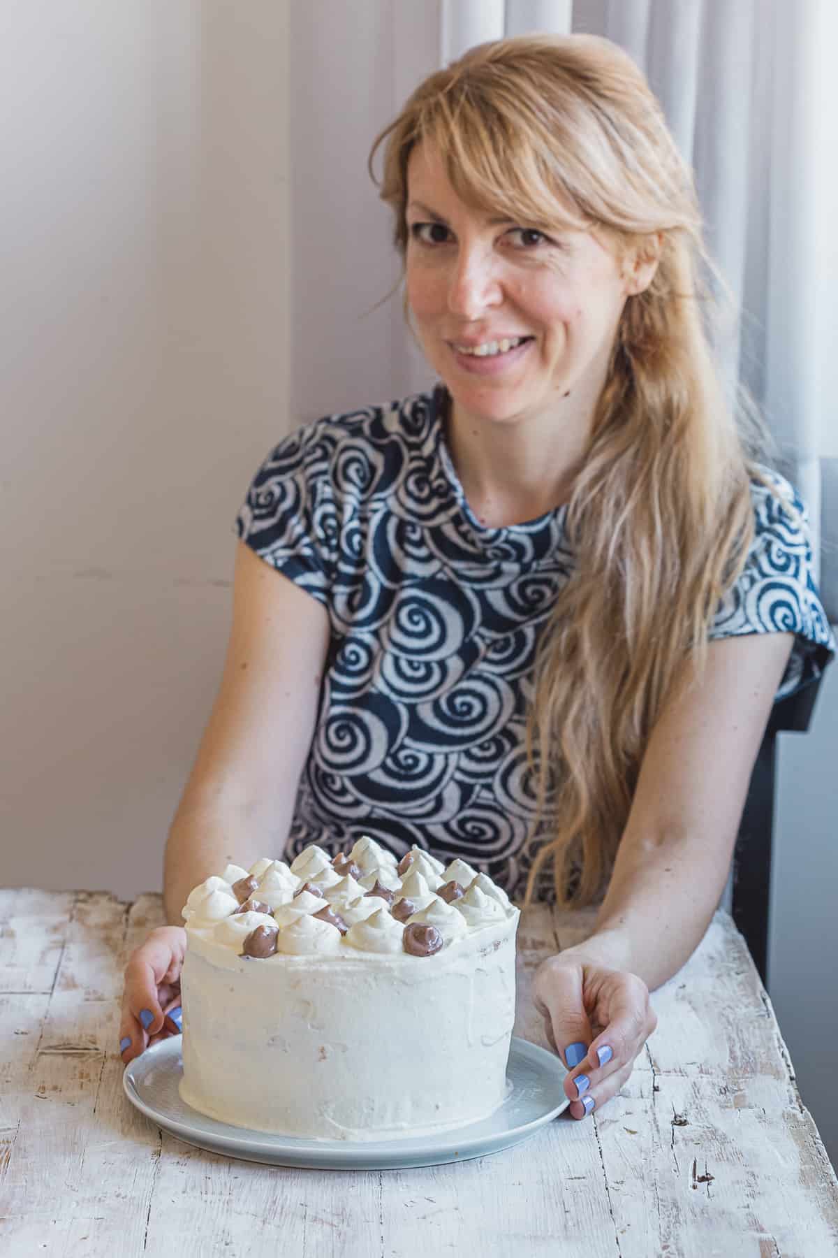Daniela with a white layer cake